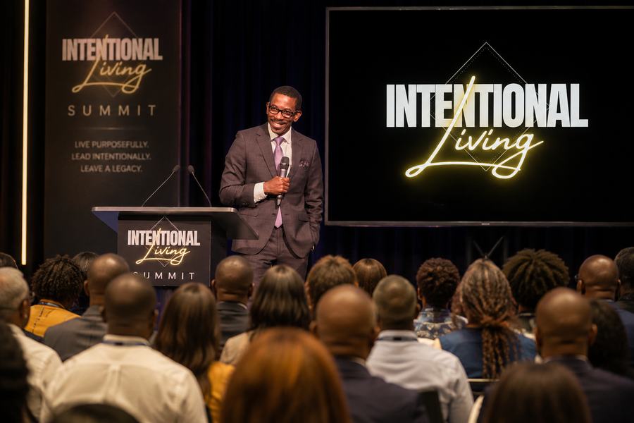 Dr. Kwame Gilbert speaking on stage at a leadership summit